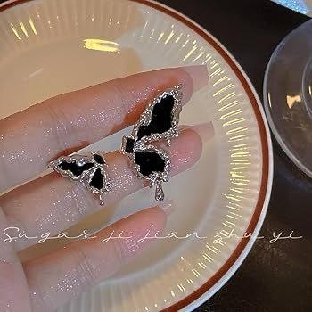 Asymmetric black butterfly stud earrings